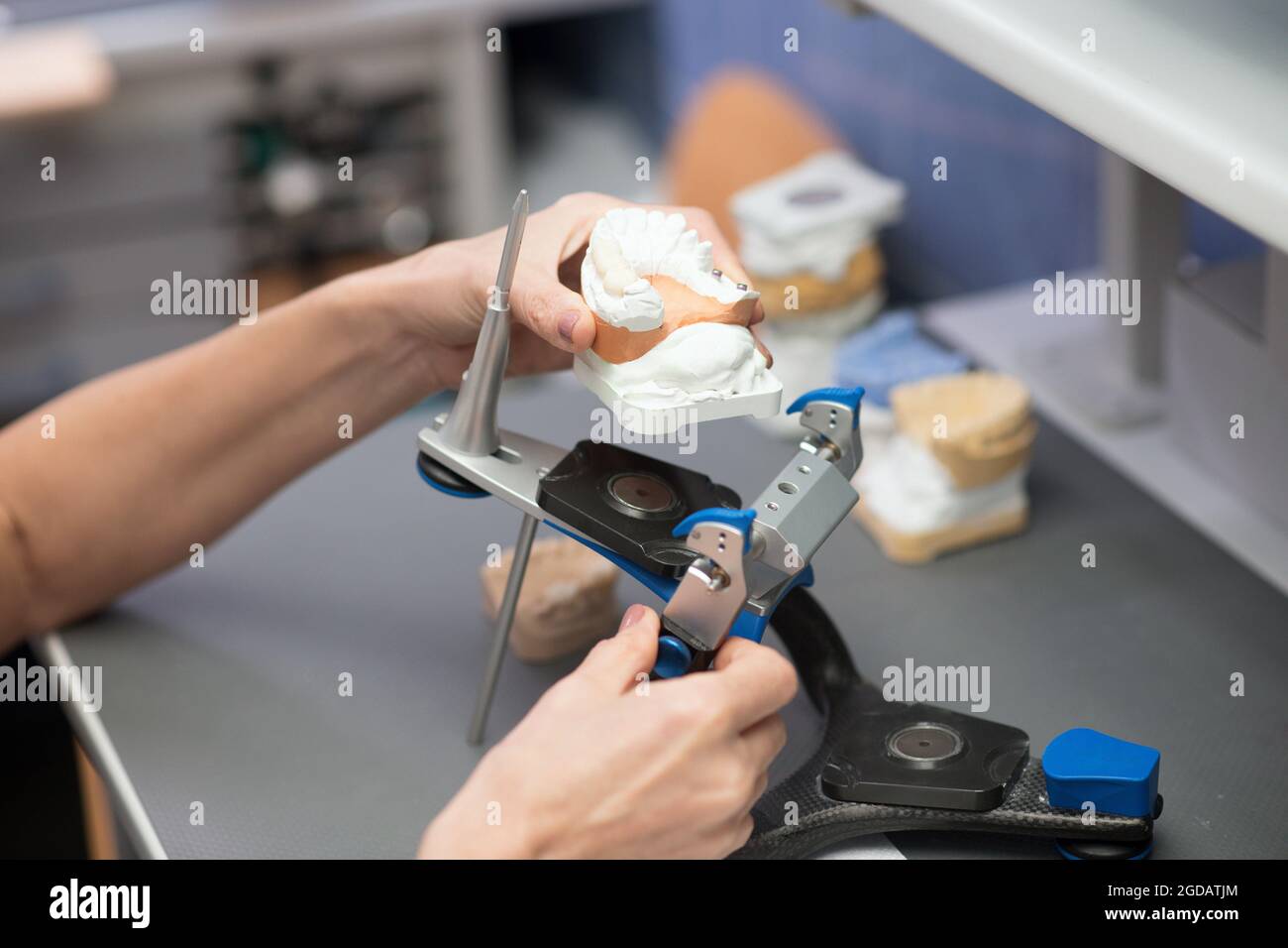 Dental prosthesis. Prosthetist working with equipment at the dental