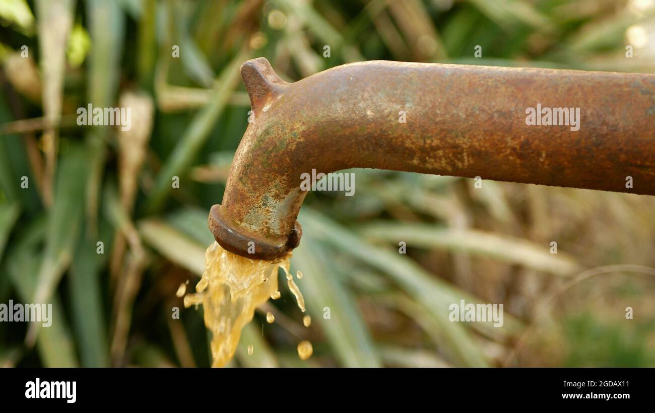 Spring water hand well pump with dirty contaminated water outlet with