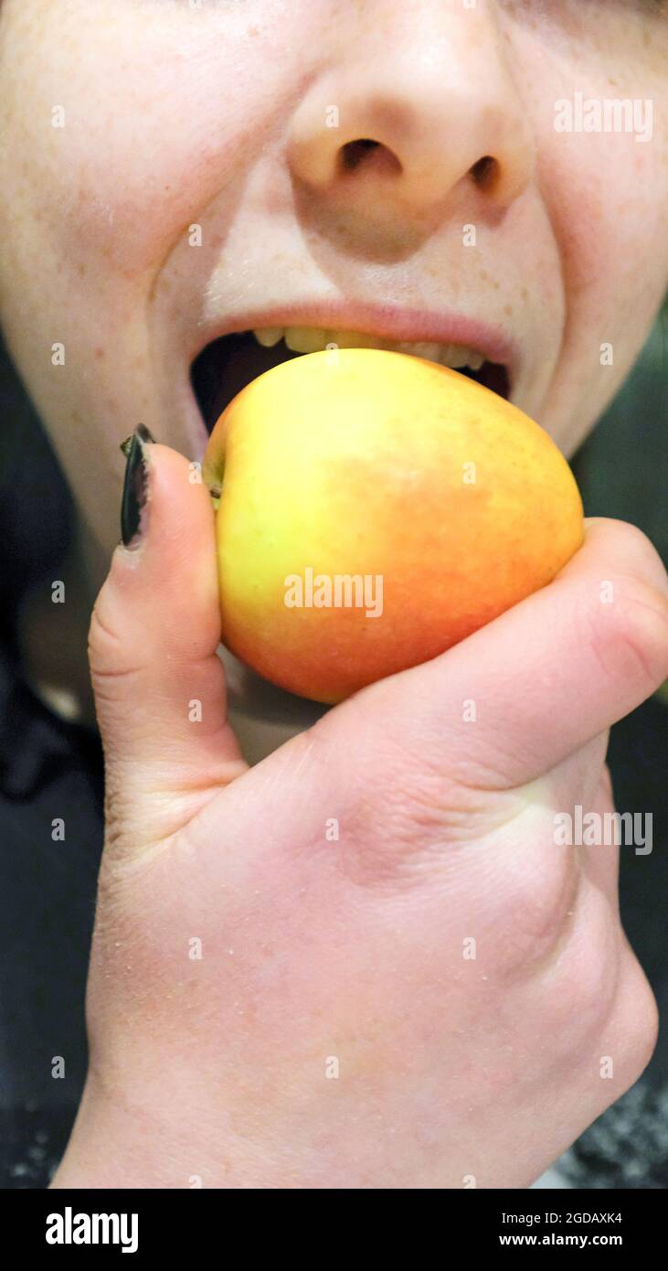 Eating an apple, one of your five a day Stock Photo