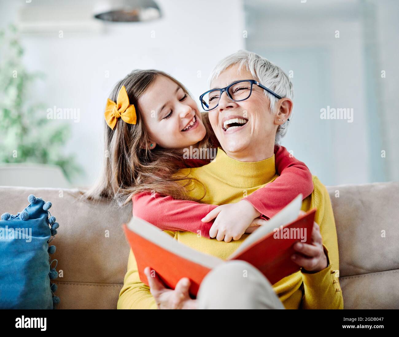 grandchild granddaughter grandma grandmother reading book girl senior Stock Photo