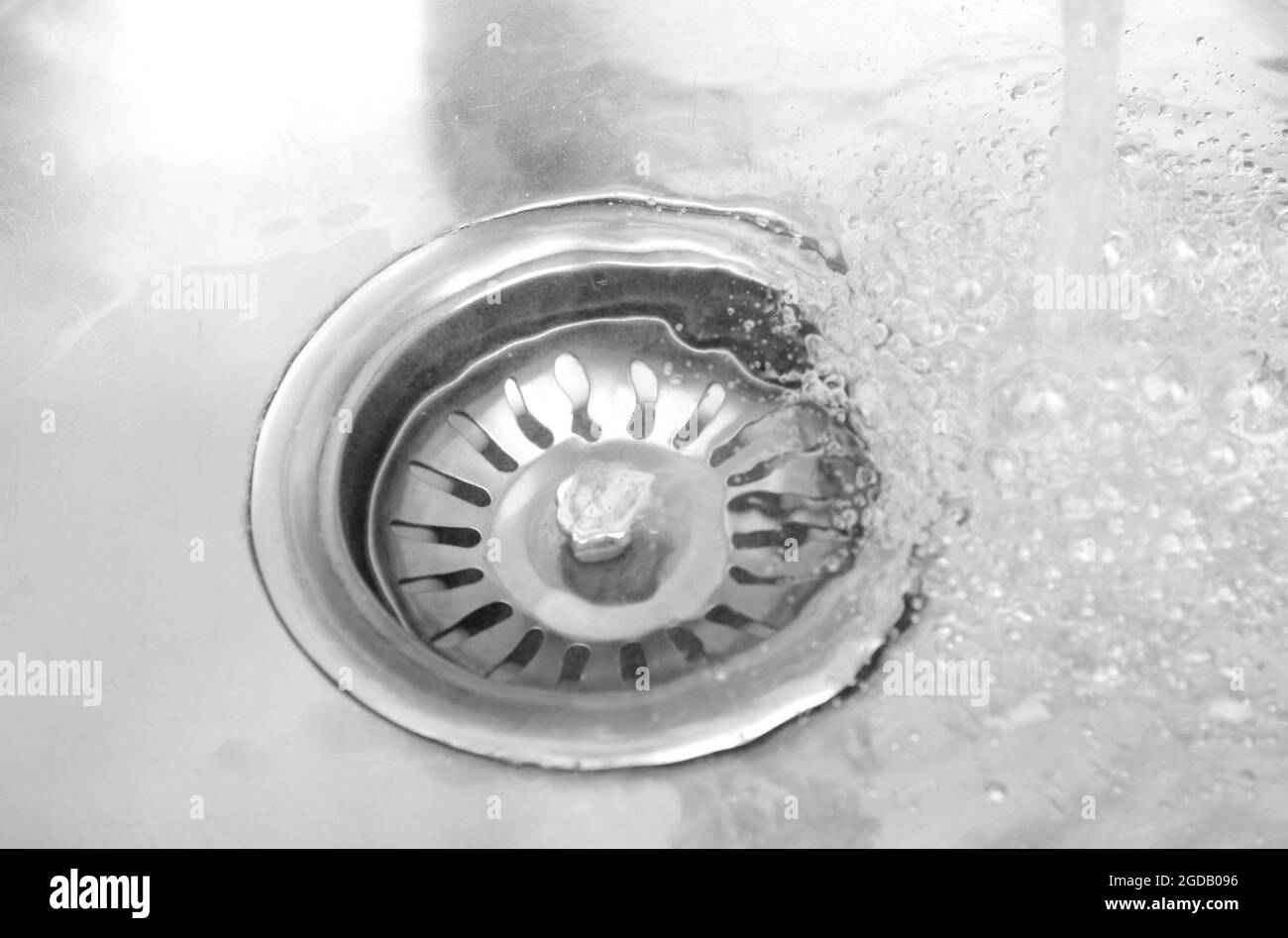 Water flowing down hole in kitchen sink Stock Photo Alamy