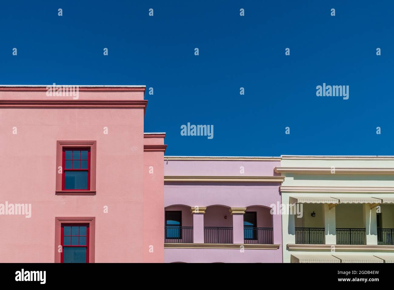 Colorful building facades against deep, bright blue sky Stock Photo