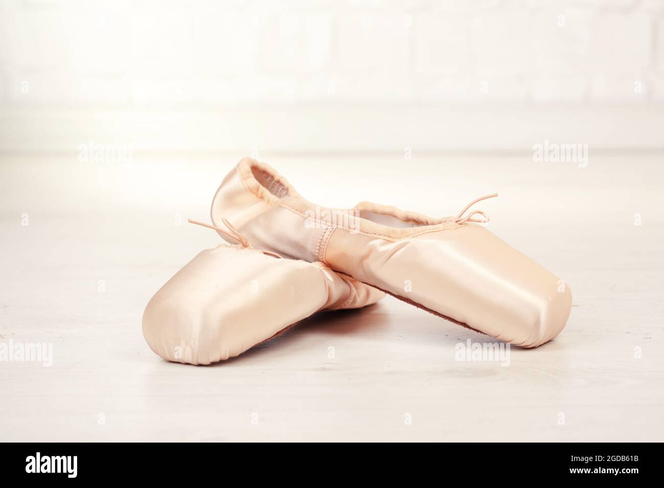 Ballet pointe shoes on floor in dance hall Stock Photo - Alamy