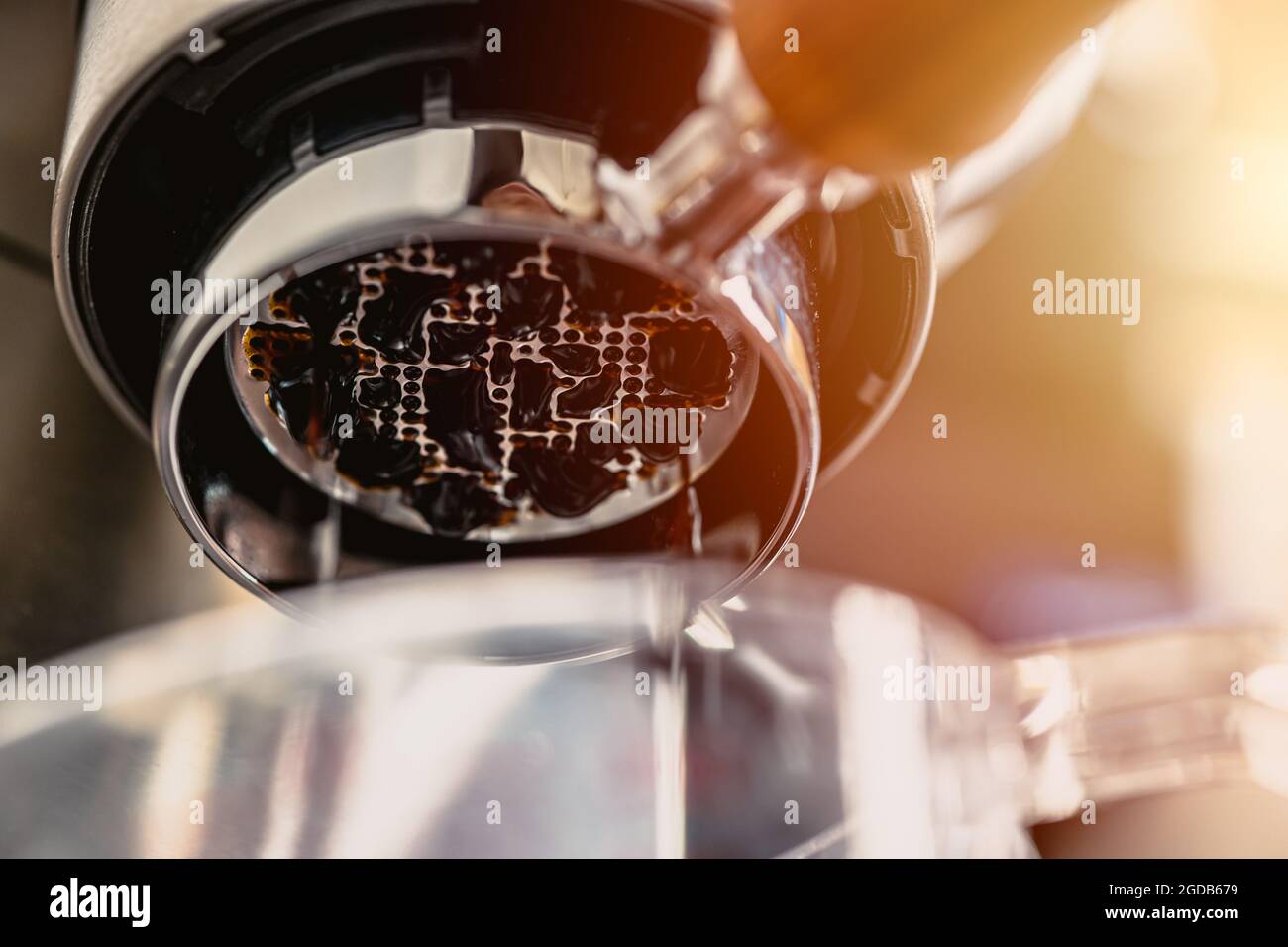 Closeup buttomless espresso coffee extraction brewing first drop fresh