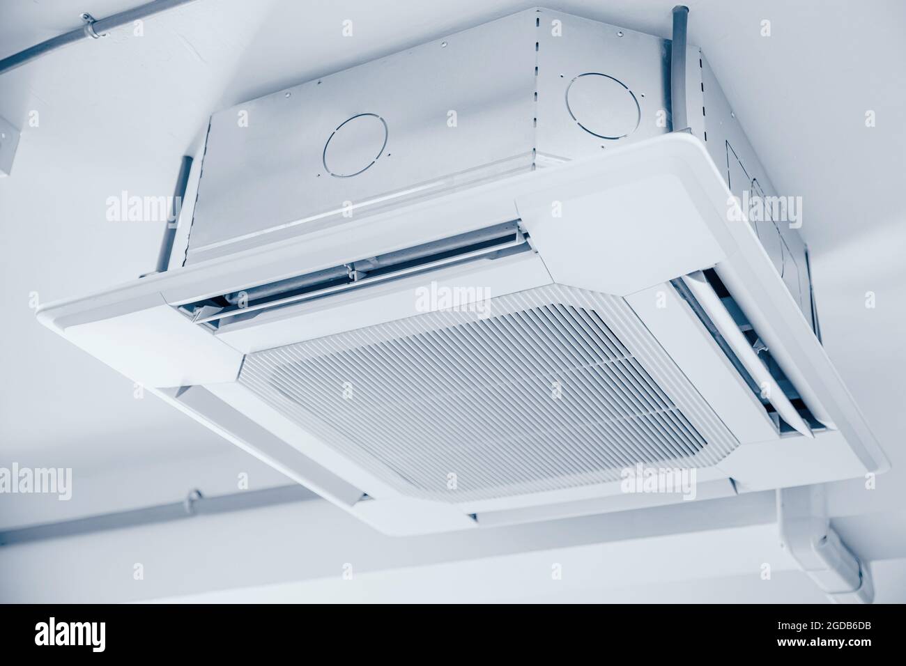 Commercial Ceiling Cassette Air Conditioners setup in office without ceiling sheet blue clean colortone. Stock Photo