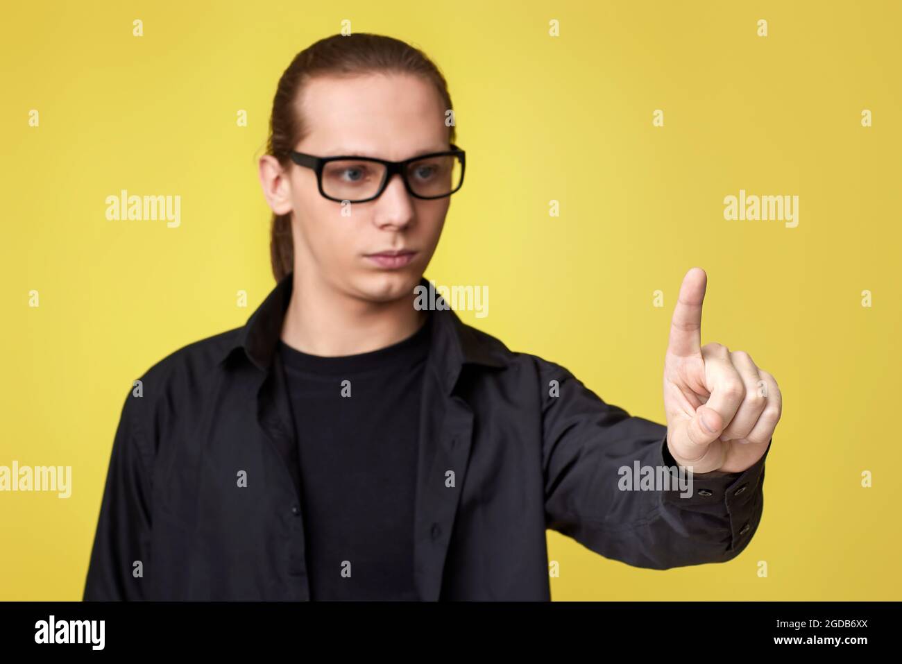 young man in glasses touching virtual screen Stock Photo