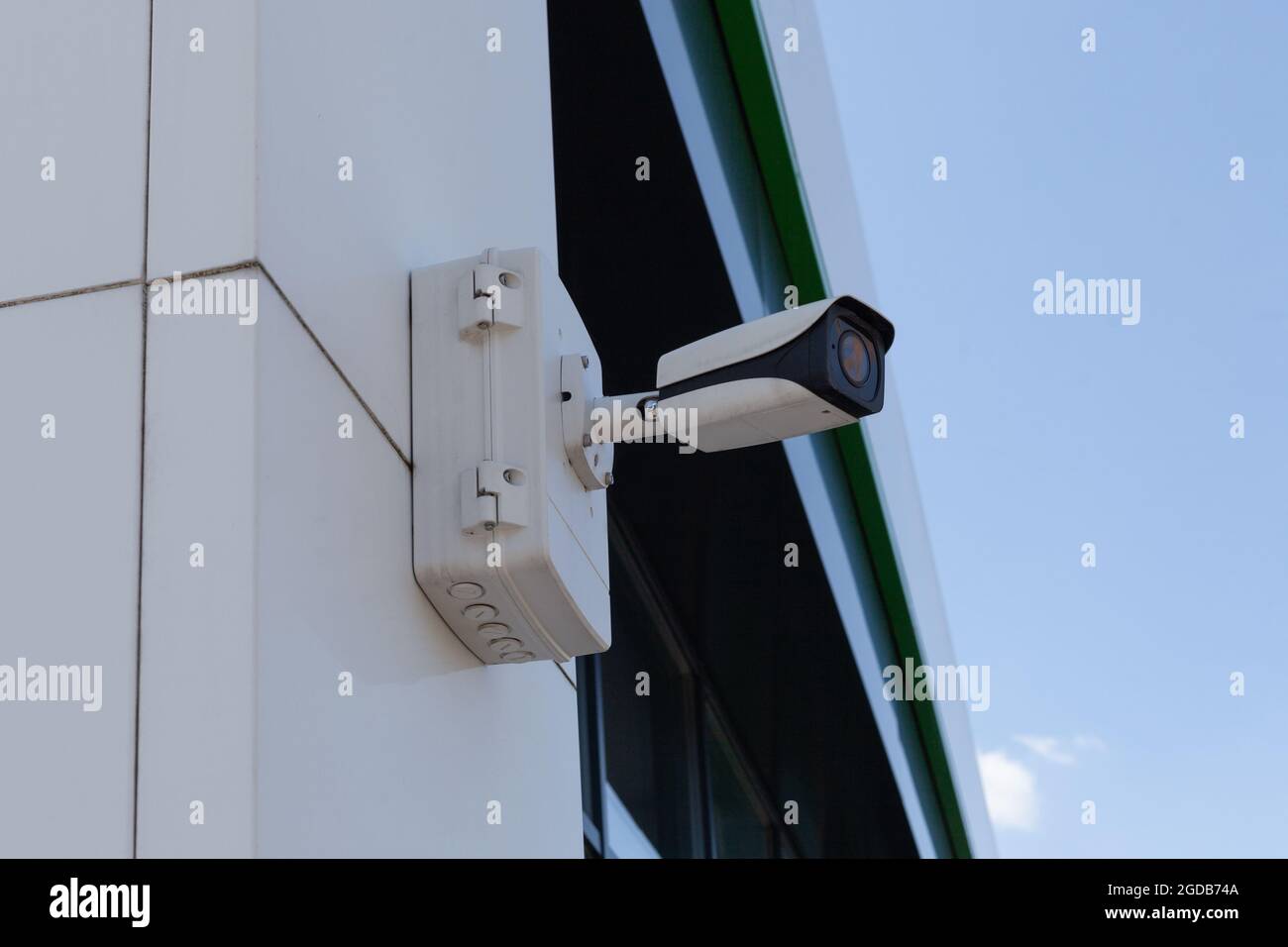 A cctv security camera proteins mounted on the building Stock Photo