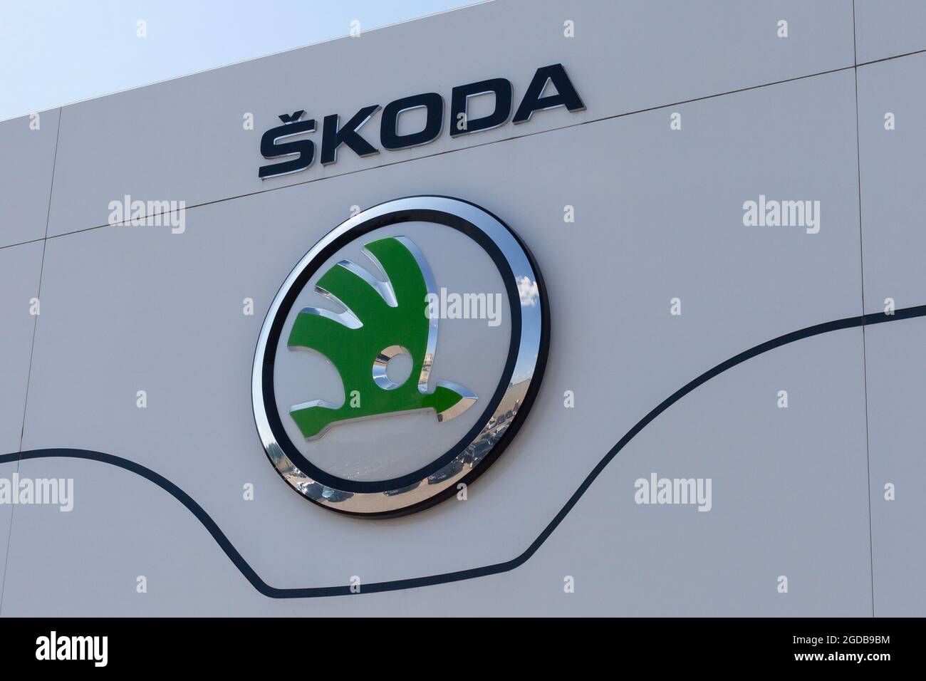 Poznan, POLAND - Jul 30, 2021: Skoda dealership sign in front of the showroom. Closeup of skoda logo on whiteboard. Stock Photo