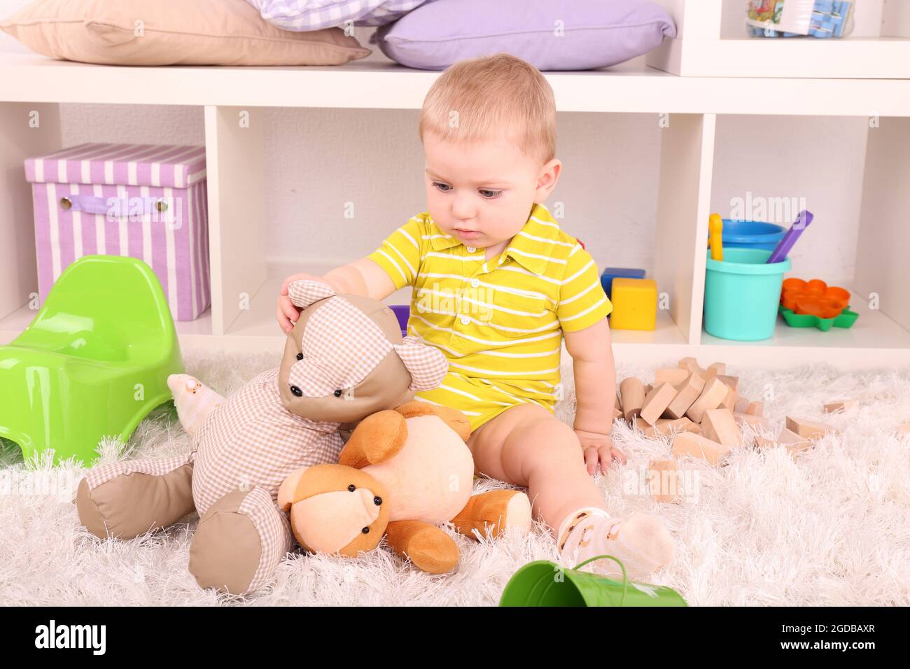 Cute little boy with toys in room Stock Photo - Alamy
