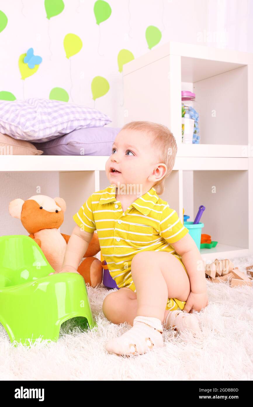 Cute little boy with toys in room Stock Photo - Alamy