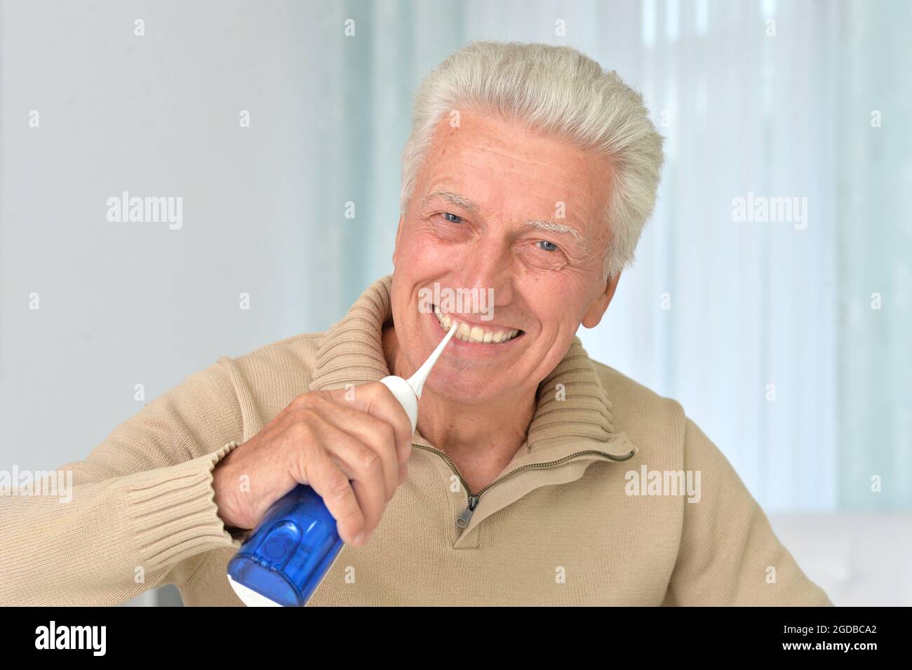 Close up portrait of cute aged guy brushing Stock Photo