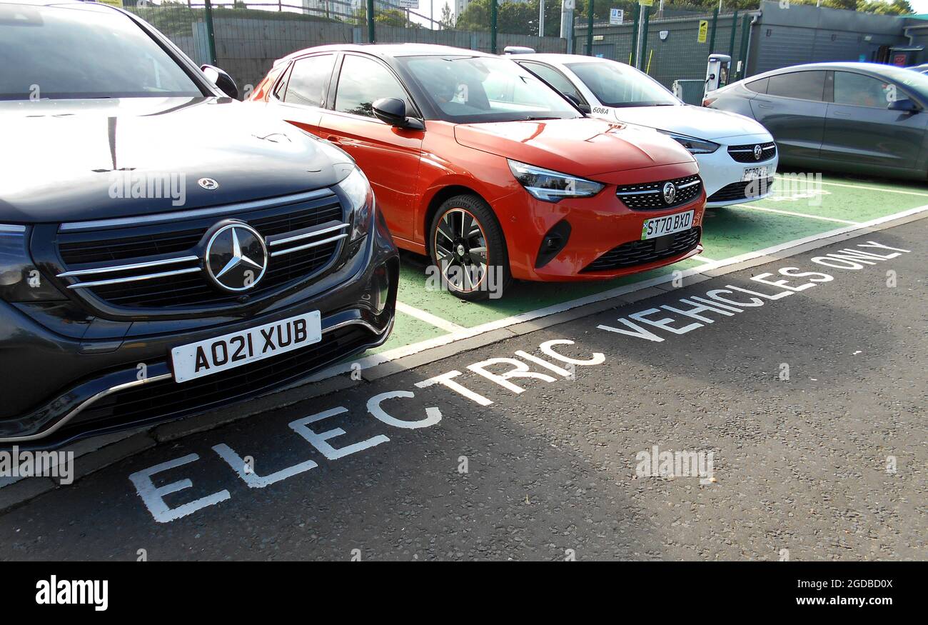 There are now, parking spaces for electric cars only. This is because there is a charging point near to these spaces to allow the driver to charge the car. ALAN WYLIE© /ALAMY Stock Photo