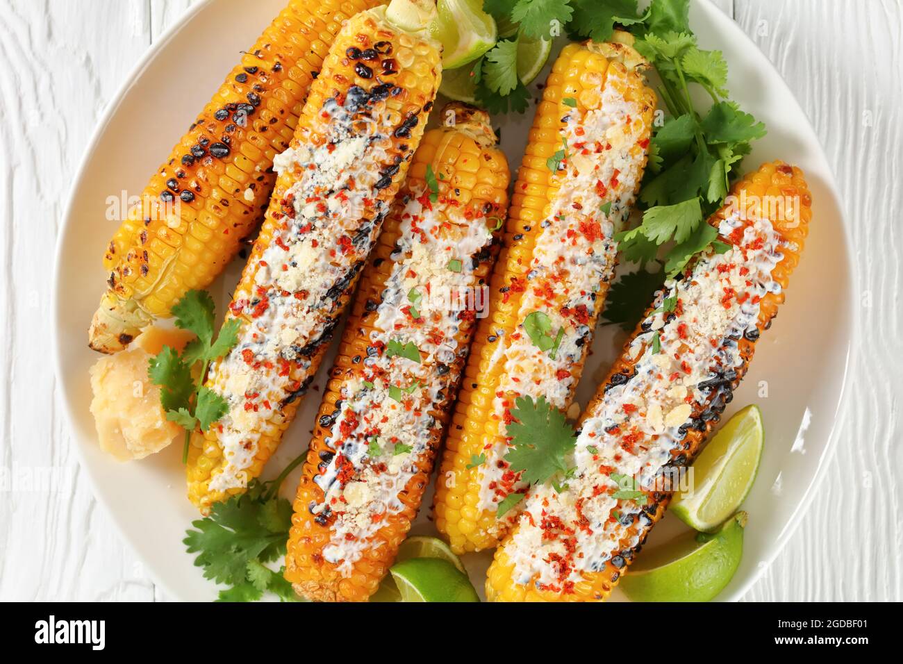 Elotes, Grilled Mexican Street Corn, charred cobs are covered in creamy