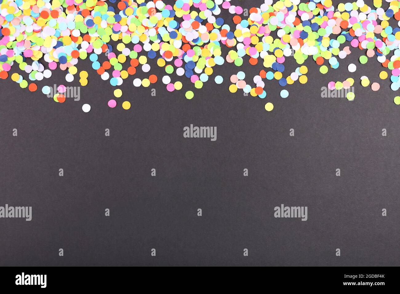 Confetti on black background Stock Photo - Alamy