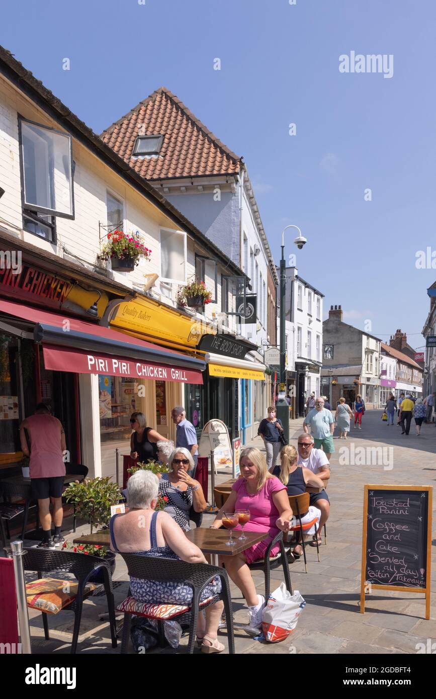 Yorkshire cafe; People sitting outside eating and drinking at a cafe in Beverley town centre in summer sunshine, Beverley Yorkshire UK Stock Photo