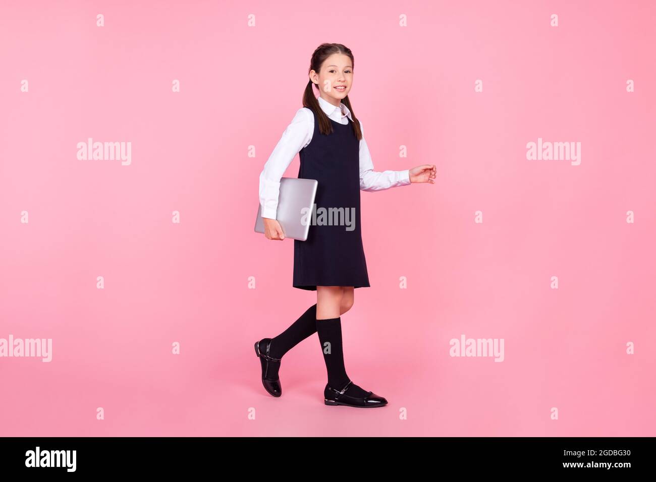 Full length body size photo schoolgirl in uniform walking on lesson ...