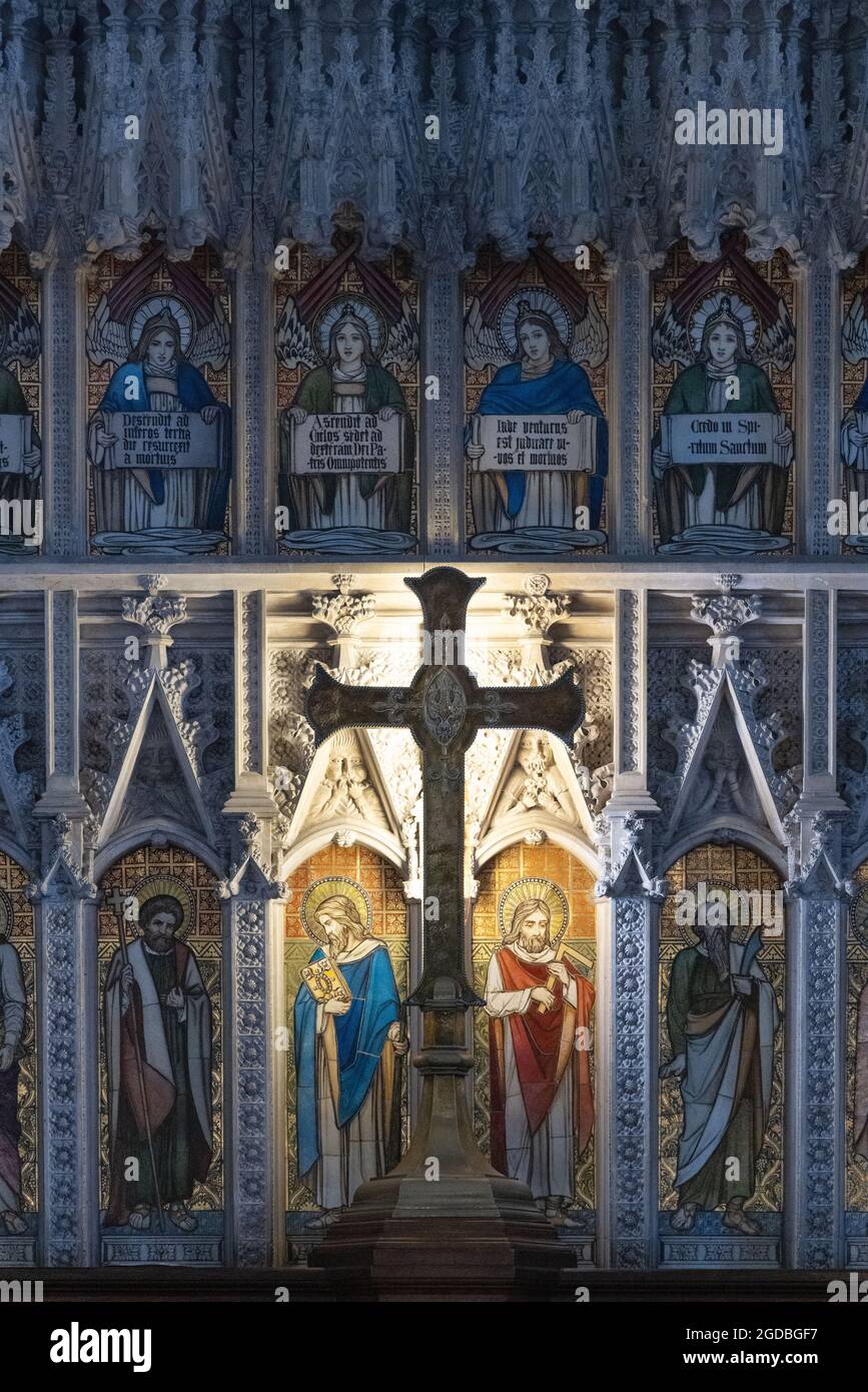 The Cross on the altar and religious images on the reredos, Beverley Minster parish church interior, Beverley Yorkshire UK Stock Photo