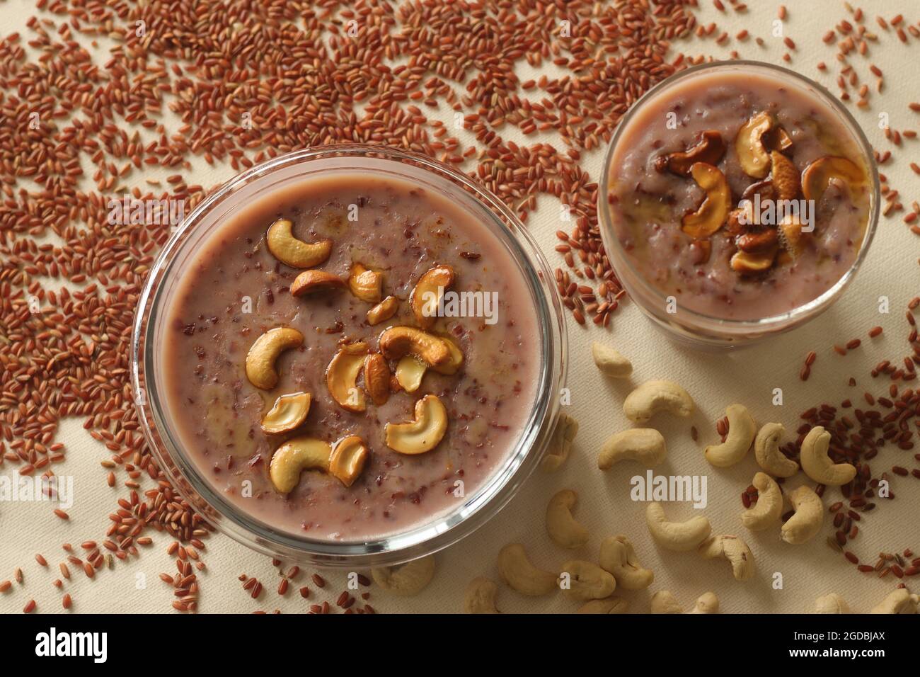 Red rice porridge with navra rice, milk and ghee. A healthy breakfast option. Shot on white background Stock Photo