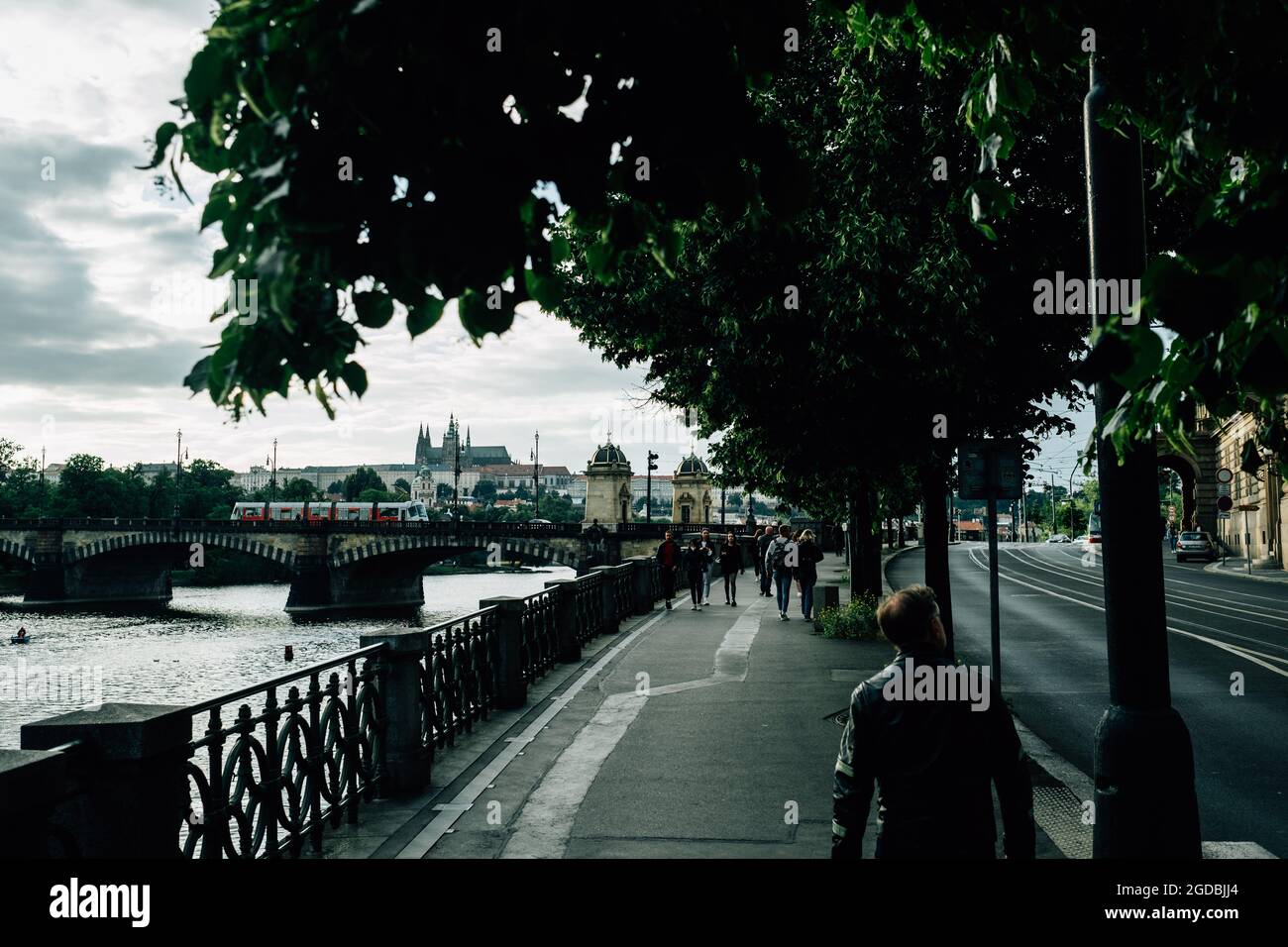 People walking by the path on the riverside Stock Photo - Alamy