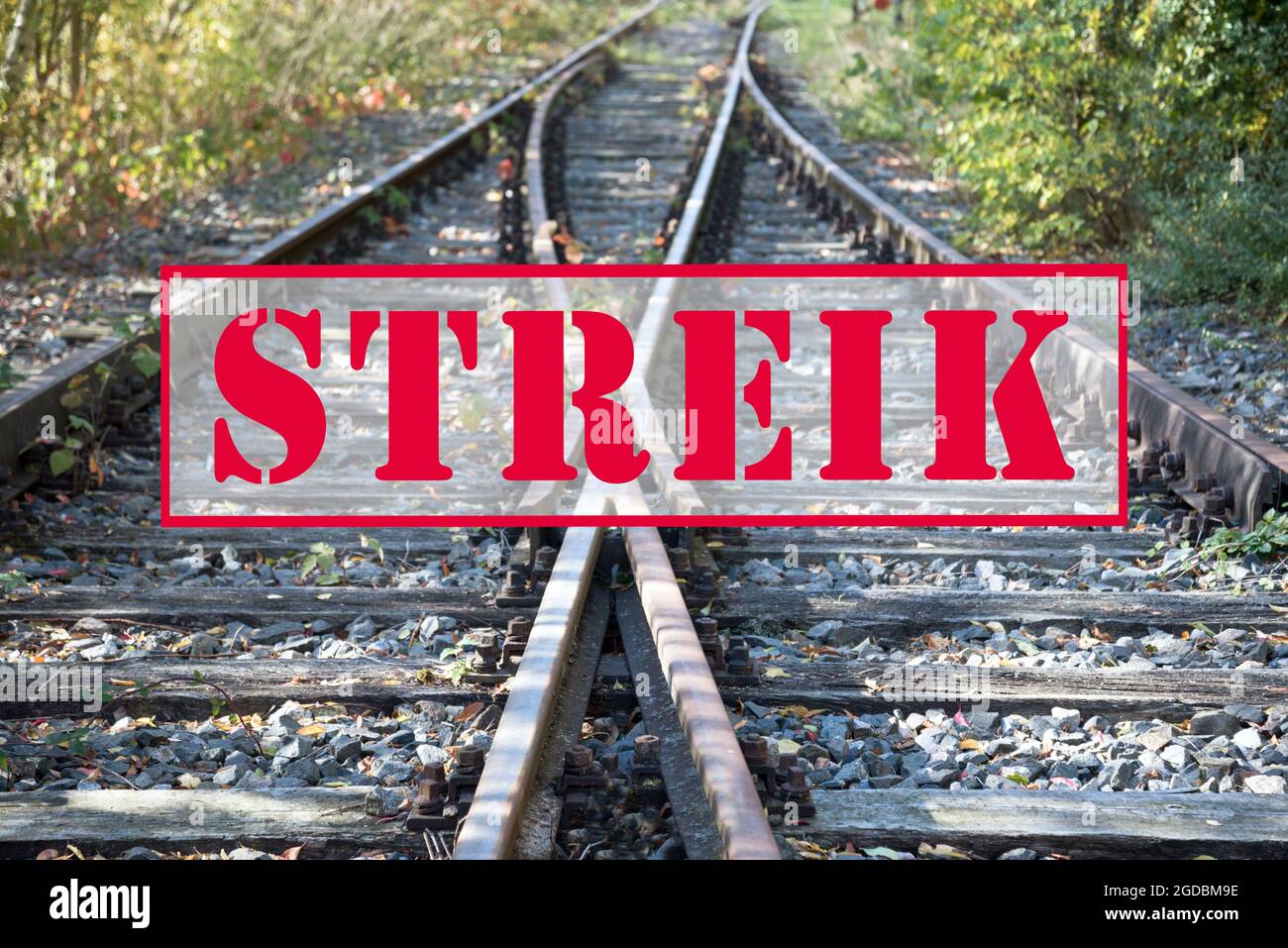 German text banner Streik (meaning strike) over old railway tracks, selected focus Stock Photo