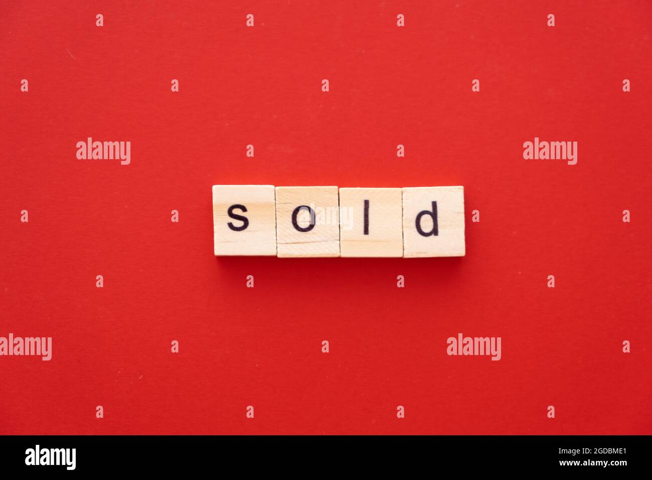 word SOLD made of wooden letters on red background with copy space ...