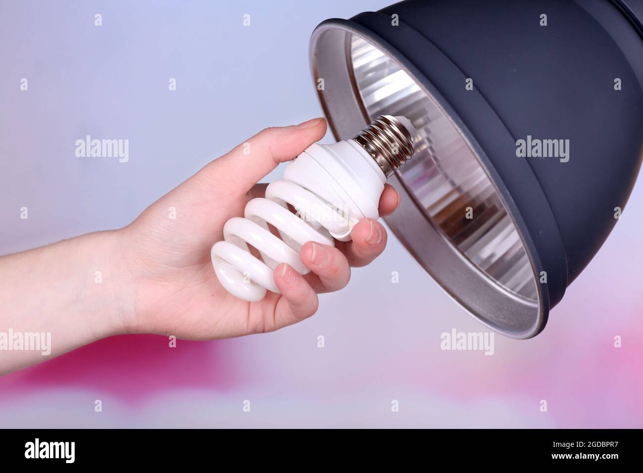 Hand changing light bulb for lamp at home Stock Photo - Alamy