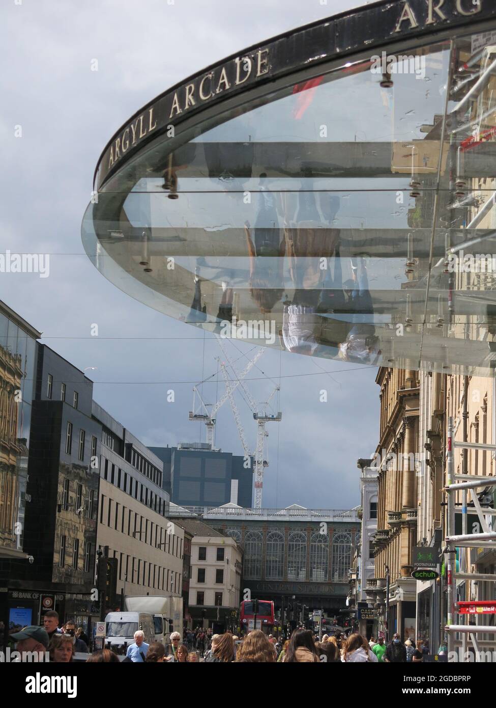 Argyle Street shoppers are reflected in the glass roof that's at the entrance to the Argyll Arcade, Glasgow's Jewellery Quarter in a covered walkway. Stock Photo