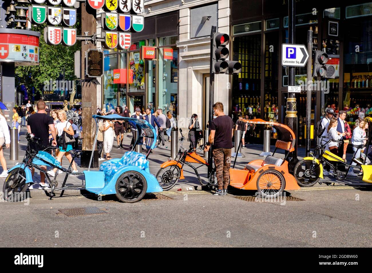 Pedal taxi drivers wait for customers in Leicester Square, London, UK. Stock Photo