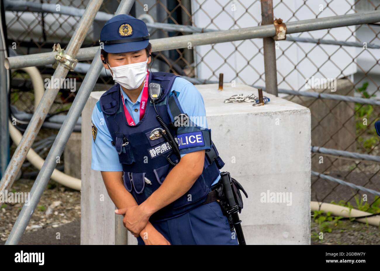 Japanese police officer resting in intense heat of the Japanese summer. Stock Photo