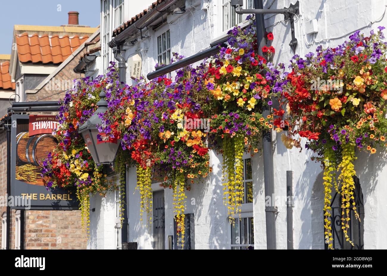 Traditional pub UK; The Barrel, a traditional english pub decked with colourful flowers in hanging baskets, Walkington, Beverley Yorkshire UK Stock Photo