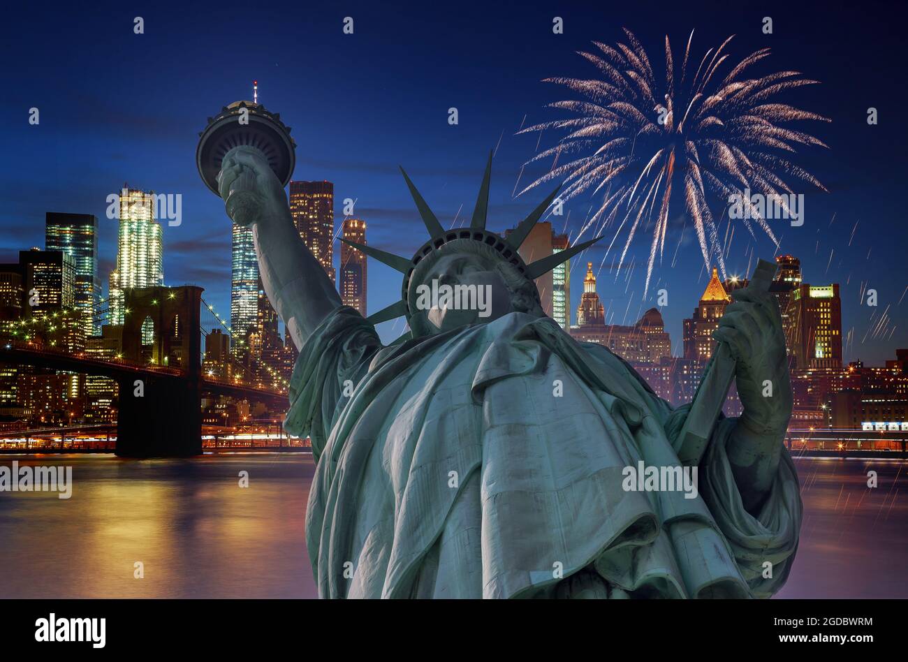Fireworks over Manhattan NY city at night with Statue of Liberty in ...