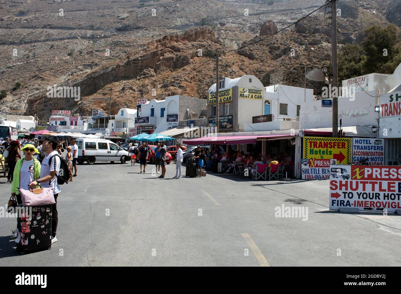 Santorini / Greece / August 27 2019 : The ferry port on the island. Picture of facilities like cafe’s, ticket and travel agencies. Stock Photo