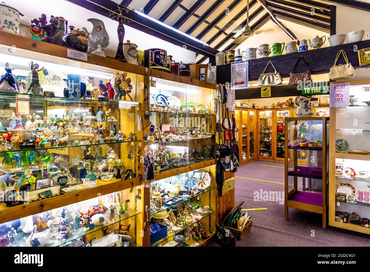 Shelves and display cabinets filled with antiques at Herts & Essex Antiques Centre, Sawbridgeworth, UK Stock Photo