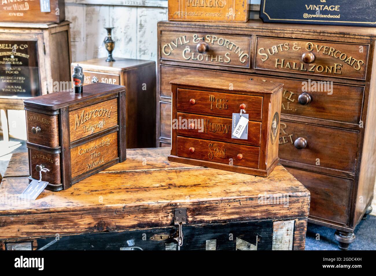Antique wooden chests of drawers on display at Maltings Antiques shop in Sawbridgeworth, UK Stock Photo