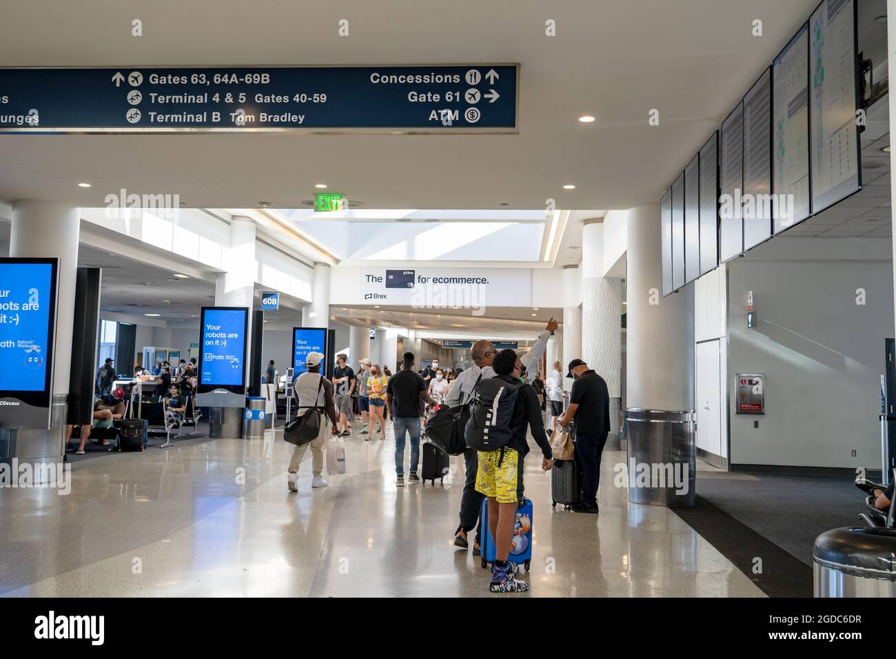 Travelers walking through LAX airport in Los Angeles Stock Photo