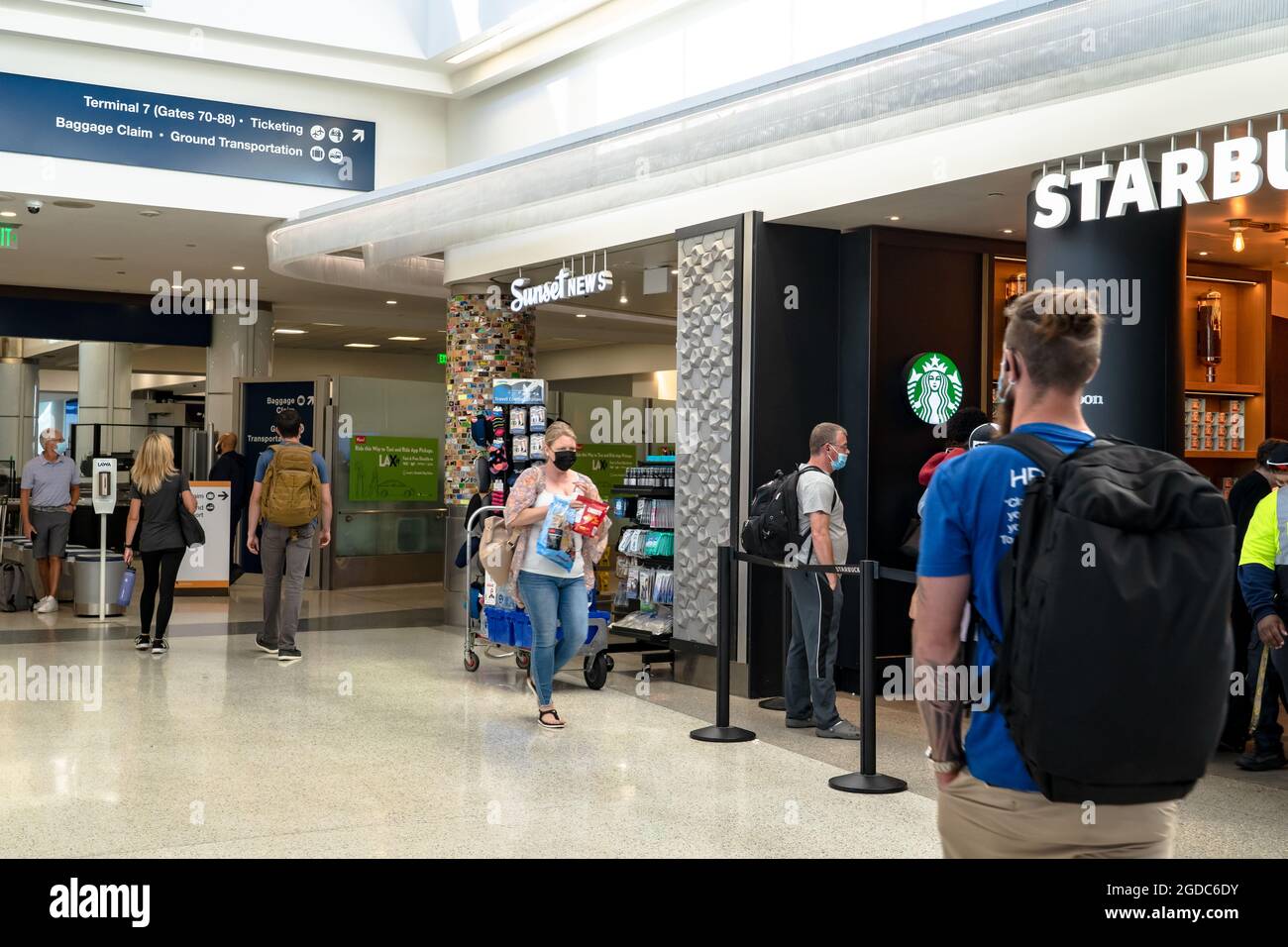 Travelers walking through LAX airport in Los Angeles Stock Photo