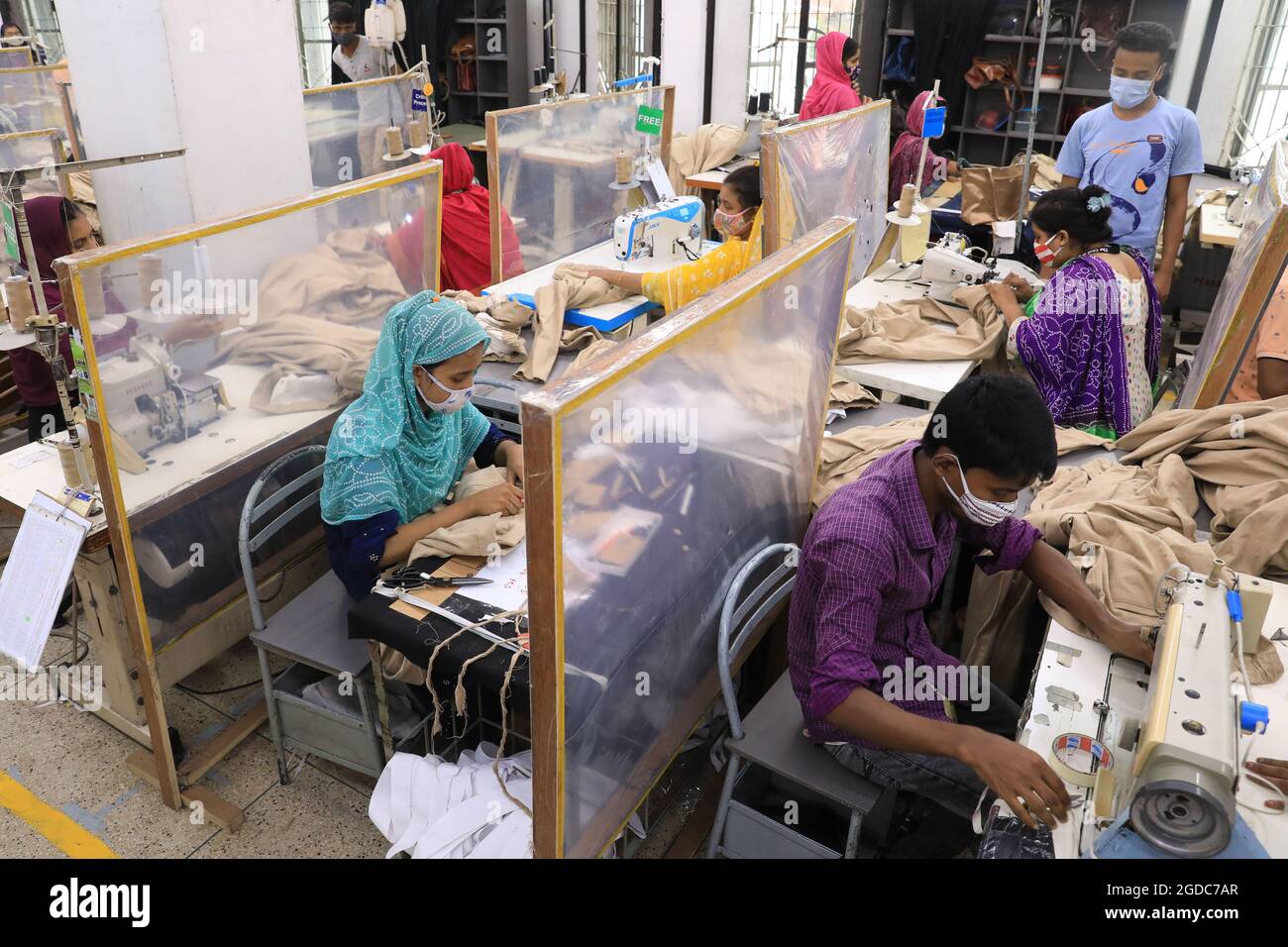 Dhaka, Bangladesh, August 12, 2021: A woman manufactures clothes in a textile factory in the Gazipur industrial zone on the outskirts of Dhaka. Despite the lockdown measures, imposed across the country by the coronavirus, Bangladeshi textile factories have resumed production of clothing, which They supply the most important brands in the world and represent 84% of the country's total exports. Bangladesh is one of the largest textile exporters in the world employing more than 4 million people, most of them women. Bangladesh's labor force is one of the cheapest in the region, and as a result, it Stock Photo