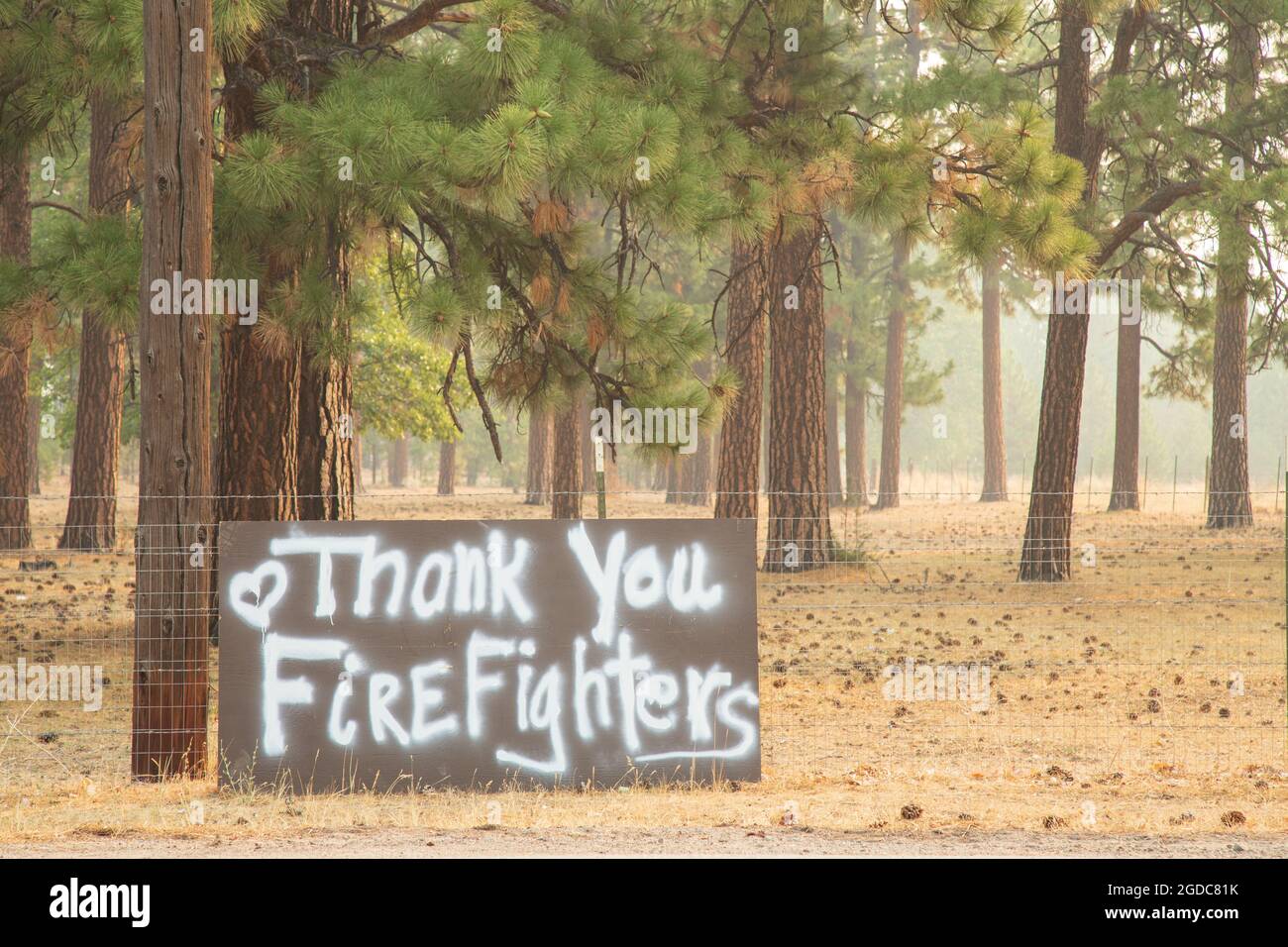 AUGUST 12, 2021 - JANESVILLE, CALIFORNIA, USA.  A sign in front of a residence expresses appreciation for firefighters as smoke fills the air. Stock Photo