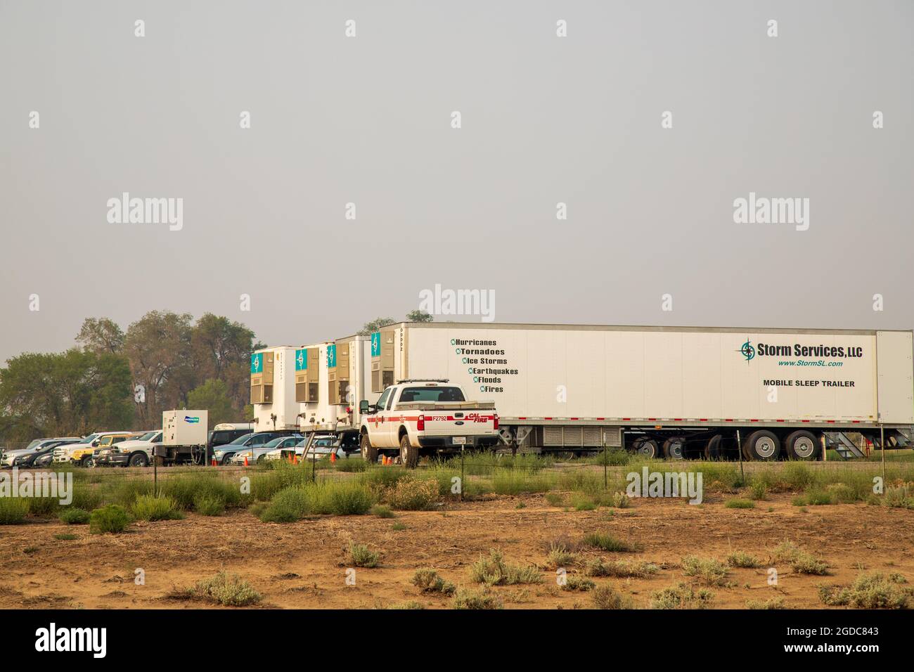 AUGUST 12, 2021 - SUSANVILLE, CALIFORNIA, USA.  Mobile sleeping quarters for off-duty fire fighters from the Dixie Fire occupy a defunct car lot. Stock Photo