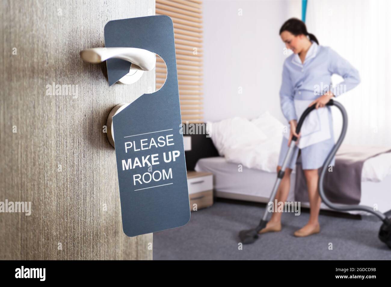 Housekeeper Cleaning Hotel Room. Bedroom Cleaner Service Stock Photo