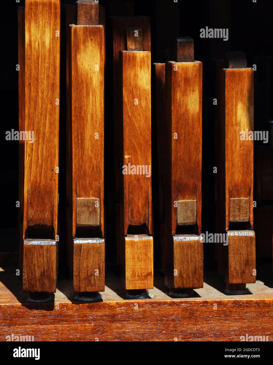 Closeup shows the very old wooden pipes on an antique pipe organ from