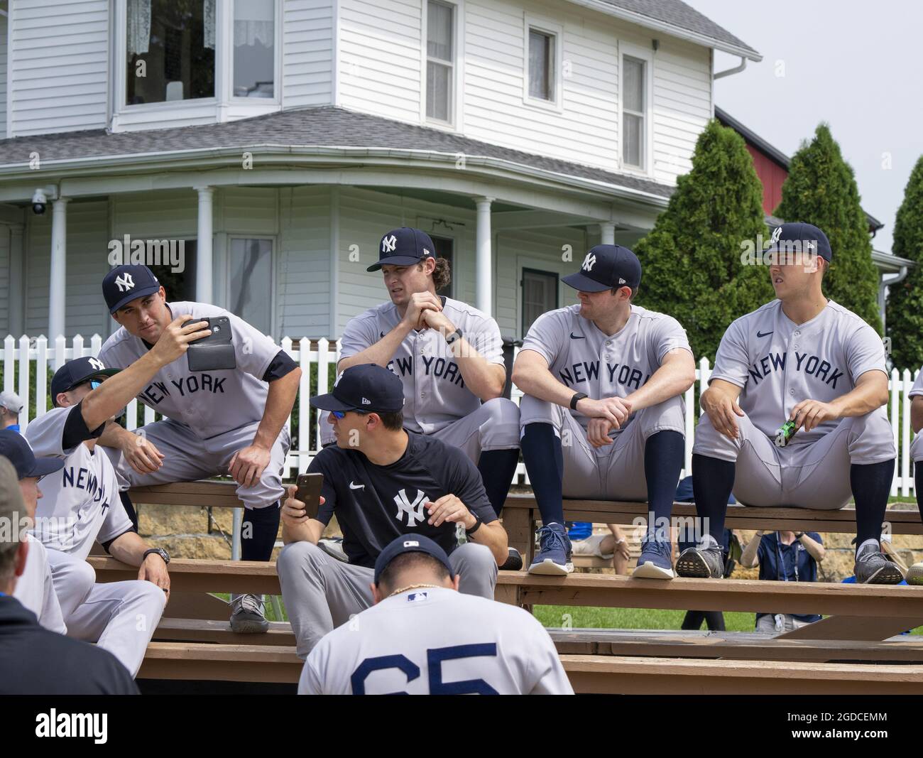 Dyersville, United States. 12th Aug, 2021. New York Yankees sit on the  stands from the 1989 movie set ballpark of the Field of Dreams as they  get ready for game at an