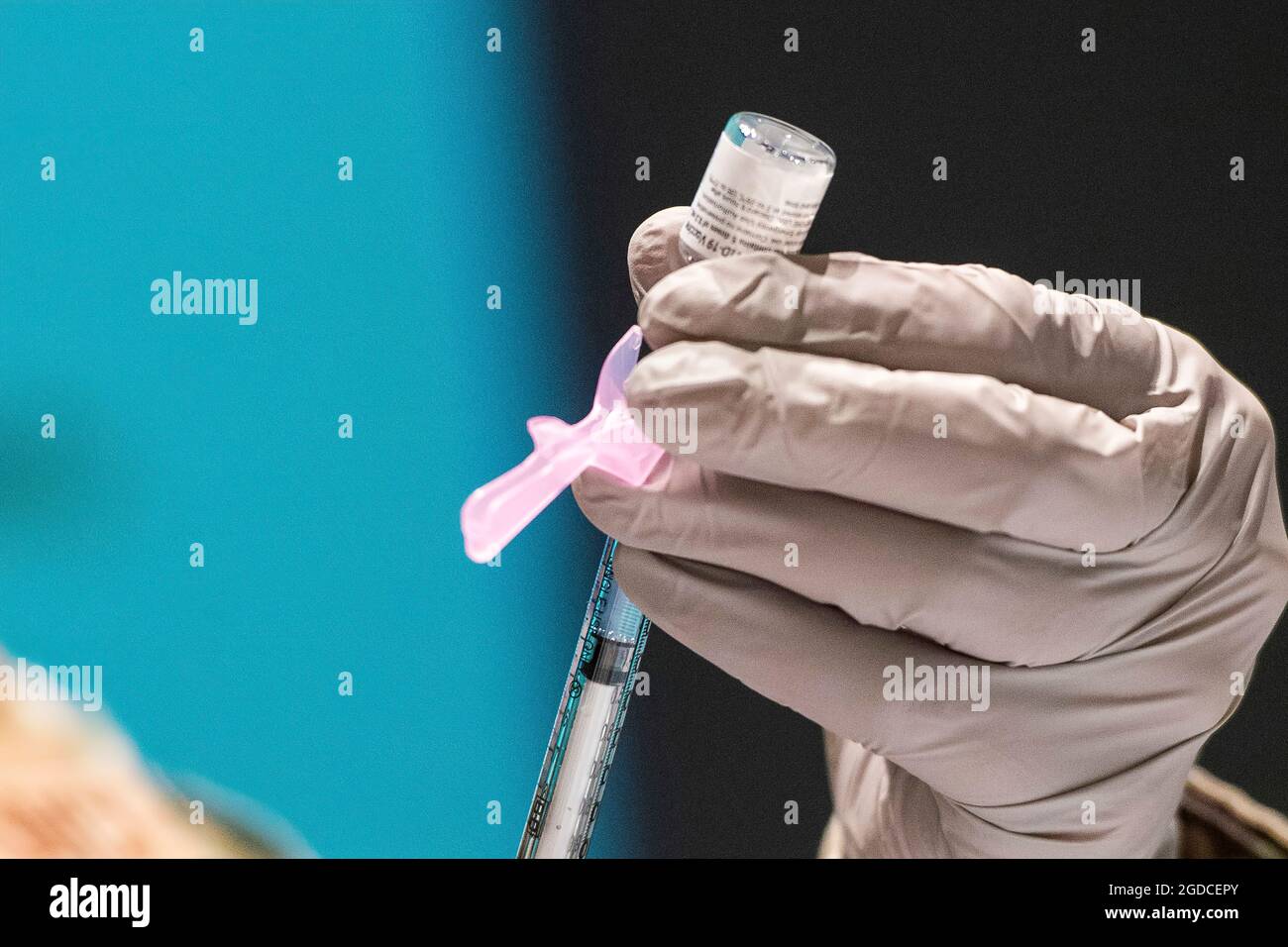 A technician loads a syringe with the COVID-19 vaccine to be delivered to waiting personnel inside the Medical Center at Wright-Patterson Air Force Base, Ohio, Jan. 5, 2021. Wright-Patt is currently in phase one of the Department of Defense’s three-phased approach to prioritize health care providers, support staff, emergency services and public safety personnel. (U.S. Air Force photo by Wesley Farnsworth) Stock Photo