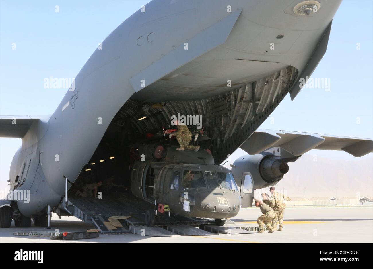 Aerial porters work with maintainers to load a UH-60L Blackhawk helicopter into a C-17 Globemaster III in support of the Resolute Support retrograde mission in  Afghanistan, June 16, 2021. (U.S. Army photo by Sgt. 1st Class Corey Vandiver/DVIDS via Sipa USA) Please note: Fees charged by the agency are for the agency’s services only, and do not, nor are they intended to, convey to the user any ownership of Copyright or License in the material. The agency does not claim any ownership including but not limited to Copyright or License in the attached material. By publishing this material you expre Stock Photo
