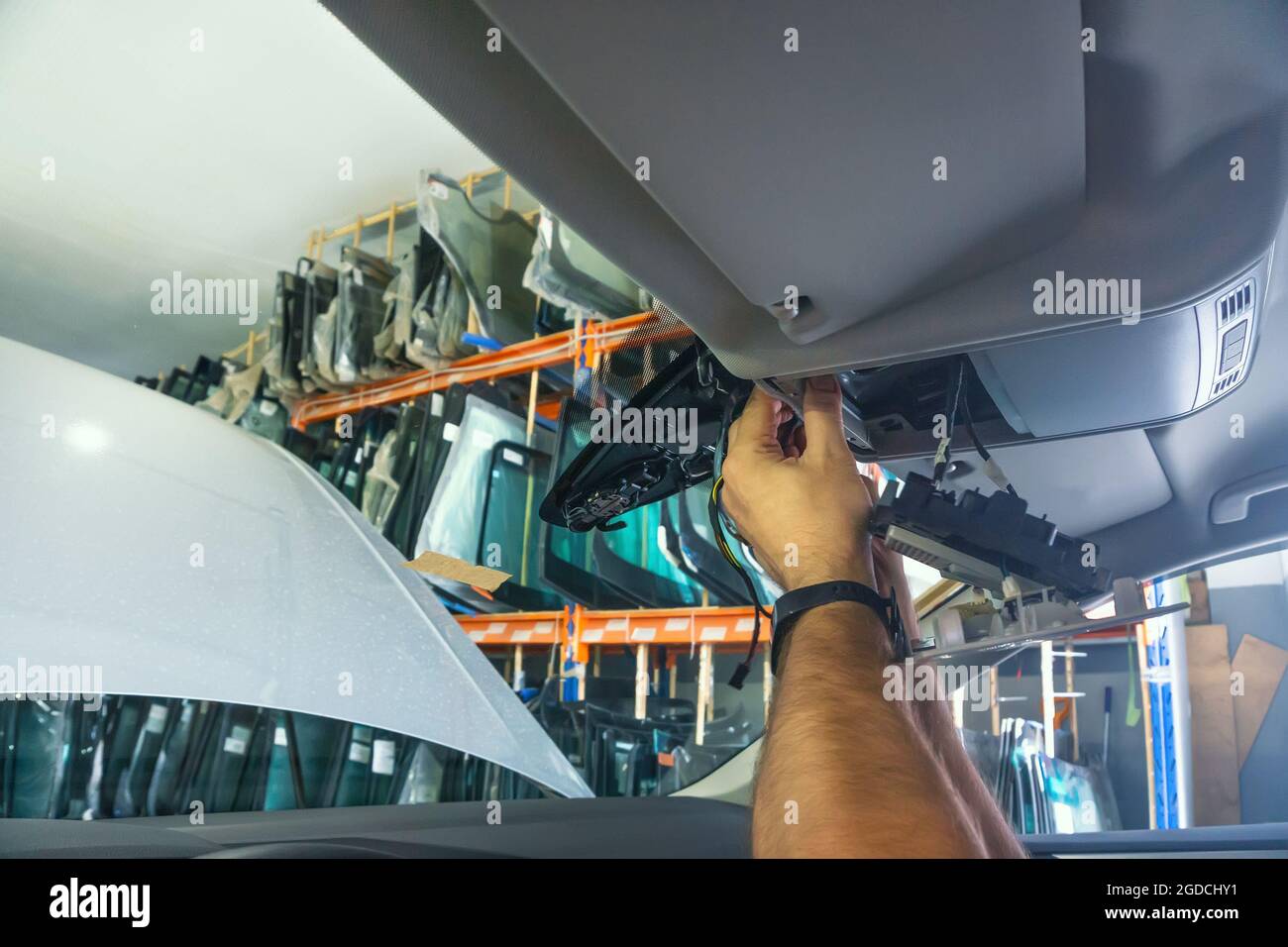 Car repair. Serviceman repairs electrical wiring inside car. Replacing