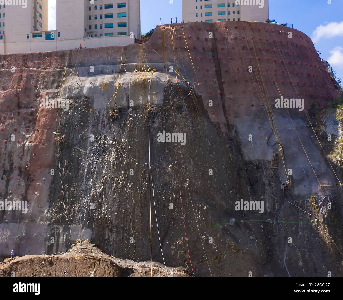 Workers reinforce a cliff face in the Santa Fe area of Mexico City, Mexico Stock Photo