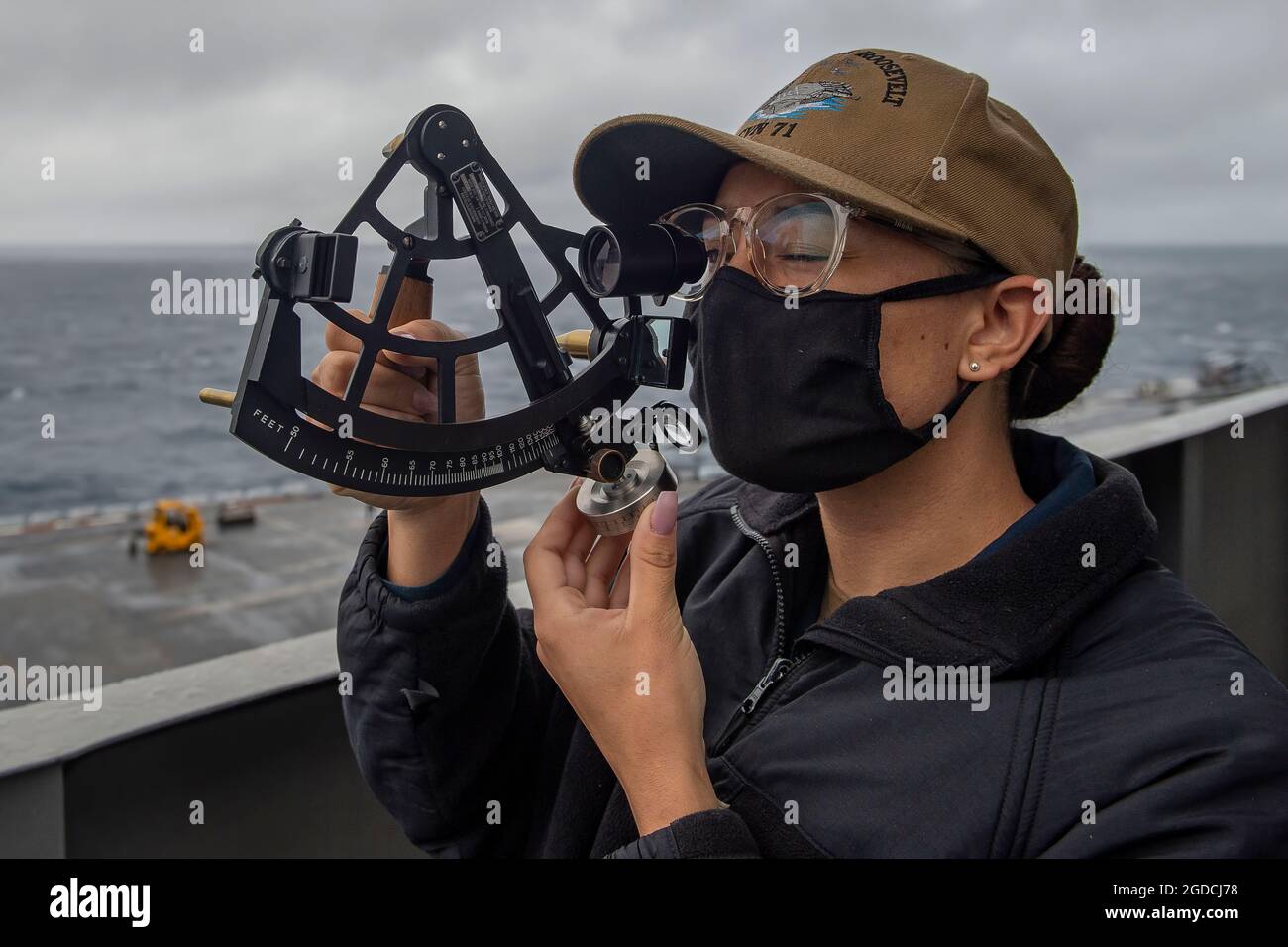 PACIFIC OCEAN (Jan. 12, 2021) – U.S. Navy Quartermaster 1st Class Reyna Montue, from Long Beach, Calif., looks through a stadimeter aboard the aircraft carrier USS Theodore Roosevelt (CVN 71) Jan. 12, 2021. The Theodore Roosevelt Carrier Strike Group is on a scheduled deployment to the U.S. 7th Fleet area of operations. As the U.S. Navy's largest forward deployed fleet, with its approximate 50-70 ships and submarines, 140 aircraft, and 20,000 Sailors in the area of operations at any given time, 7th Fleet conducts forward-deployed naval operations in support of U.S. national interests throughou Stock Photo