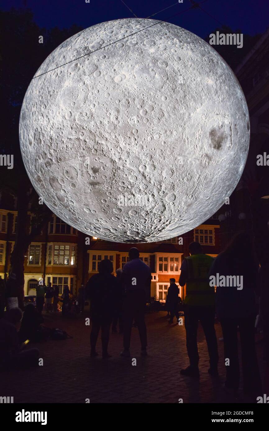London, United Kingdom. 12th August 2021. Museum of the Moon installation artwork by Luke Jerram at Kensington Town Square, part of the Kensington + Chelsea Festival. The moon is covered in detailed NASA images of the lunar surface, and measures seven metres in diameter. (Credit: Vuk Valcic / Alamy Live News) Stock Photo