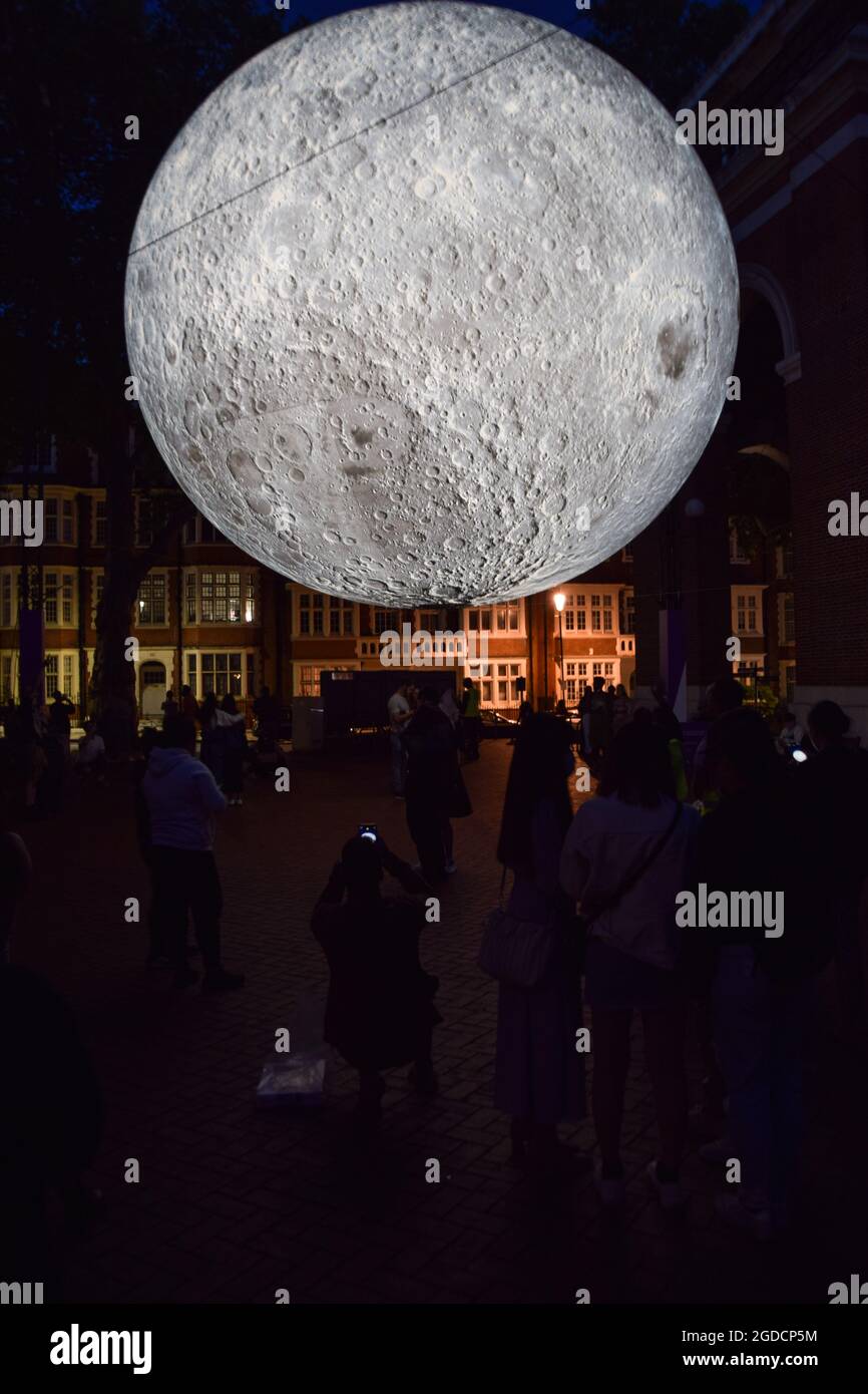 London, United Kingdom. 12th August 2021. Museum of the Moon installation artwork by Luke Jerram at Kensington Town Square, part of the Kensington + Chelsea Festival. The moon is covered in detailed NASA images of the lunar surface, and measures seven metres in diameter. (Credit: Vuk Valcic / Alamy Live News) Stock Photo