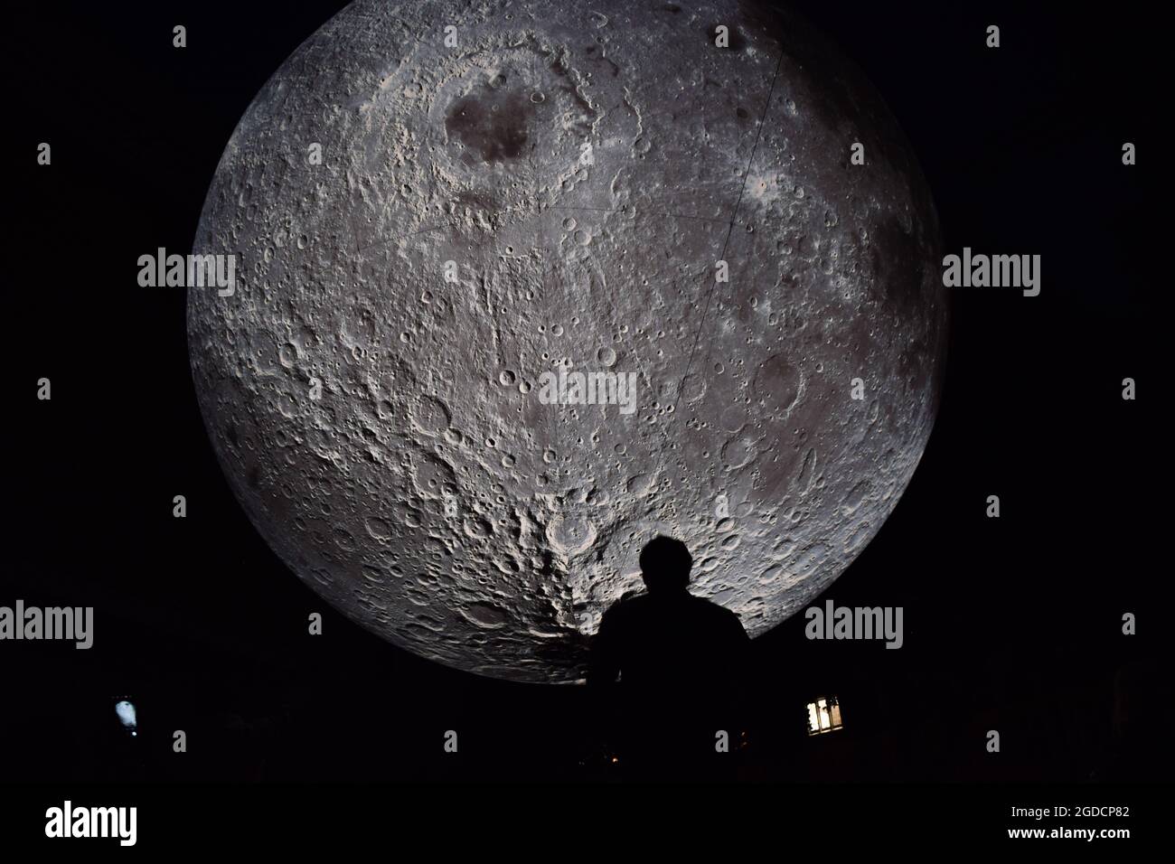 London, United Kingdom. 12th August 2021. Museum of the Moon installation artwork by Luke Jerram at Kensington Town Square, part of the Kensington + Chelsea Festival. The moon is covered in detailed NASA images of the lunar surface, and measures seven metres in diameter. (Credit: Vuk Valcic / Alamy Live News) Stock Photo